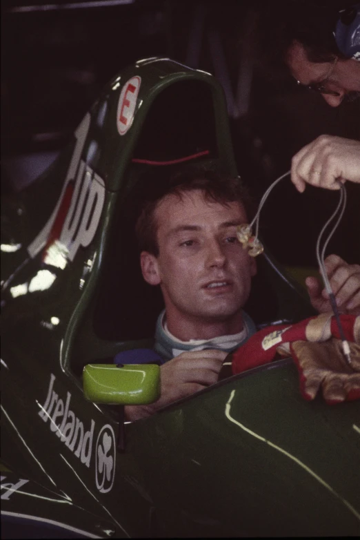 a man sitting in a race car that is parked