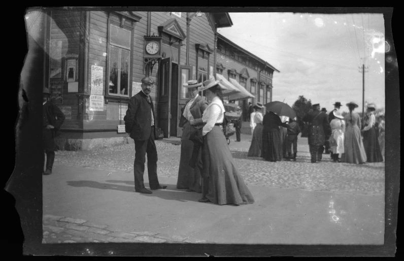 old fashioned pograph of man and woman standing outside store