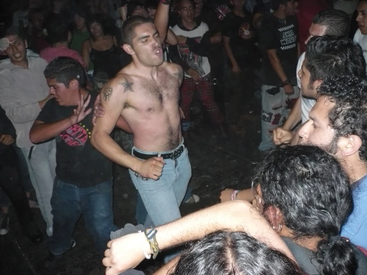 a man with  standing in the middle of a crowd