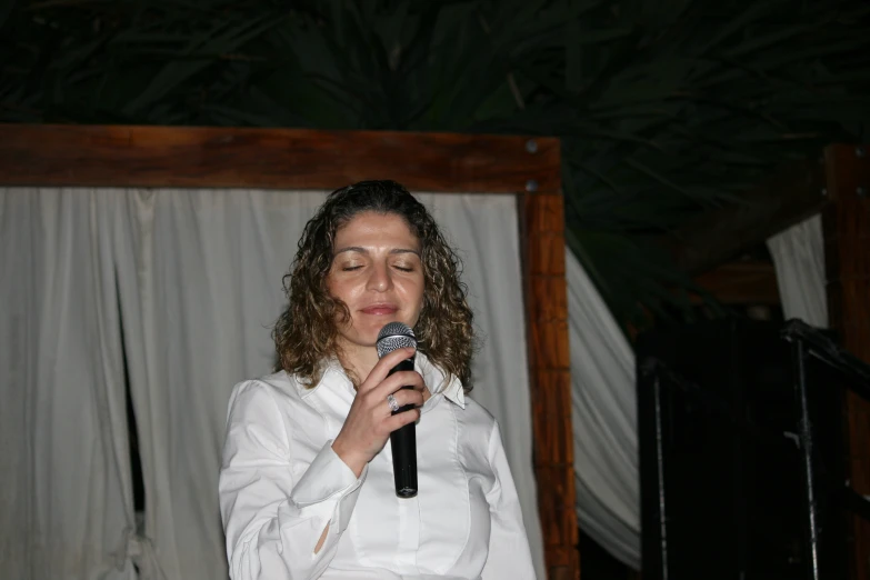 a woman holding a microphone up to her face