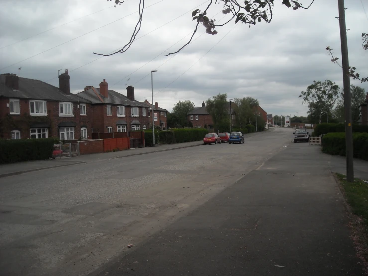 a street with several cars parked on the side