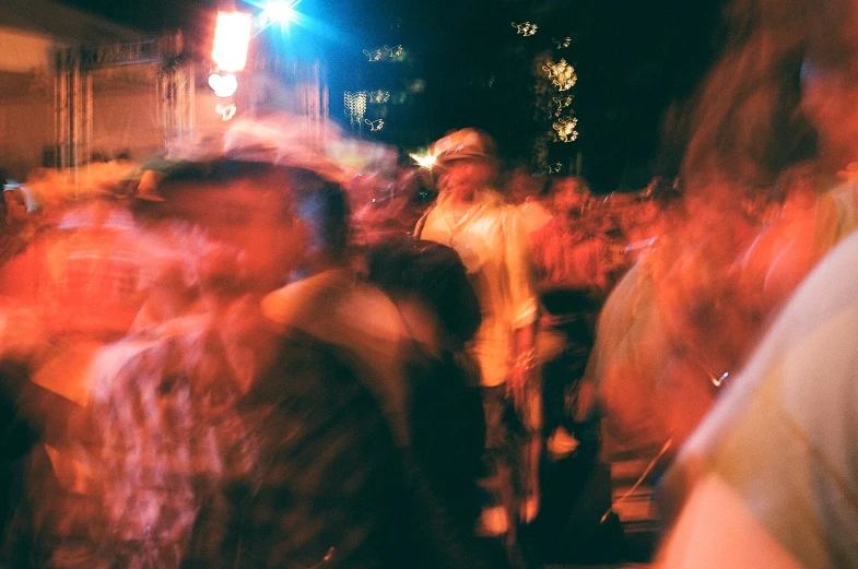 blurred image of people walking down a street