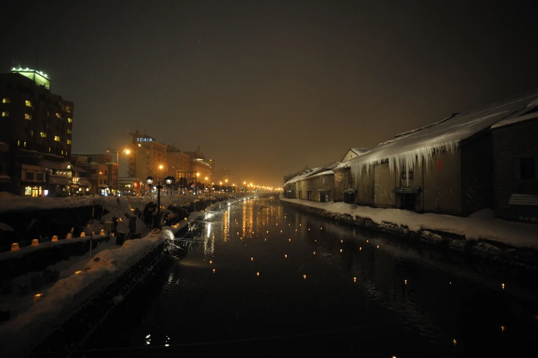 city view of a canal with buildings and street lights