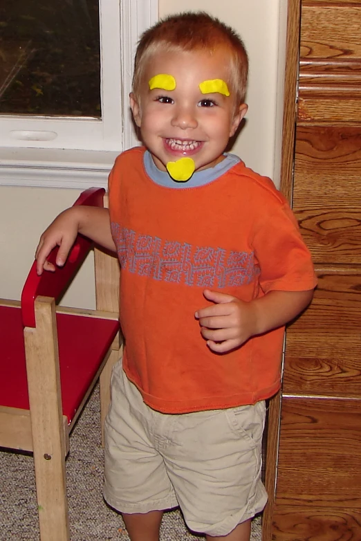 a little boy with yellow eye patches on his eyes