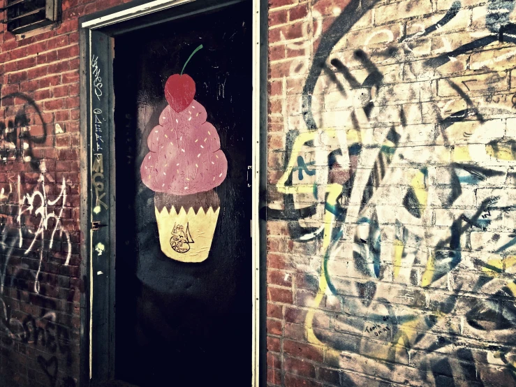 an ice cream cone is on the wall of a building