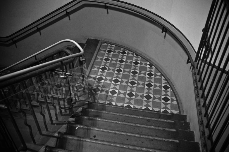 the stairs have checkered tiles in black and white