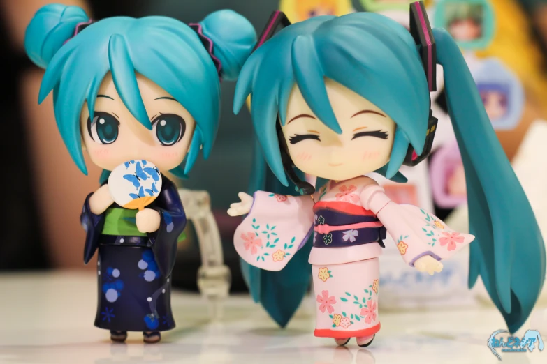 two cute anime dolls standing beside each other