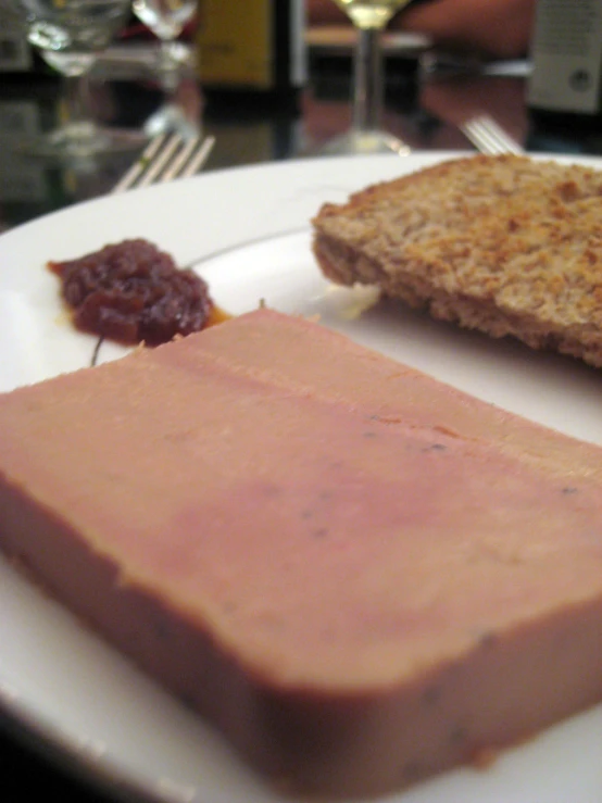 the plate has meat and bread on it