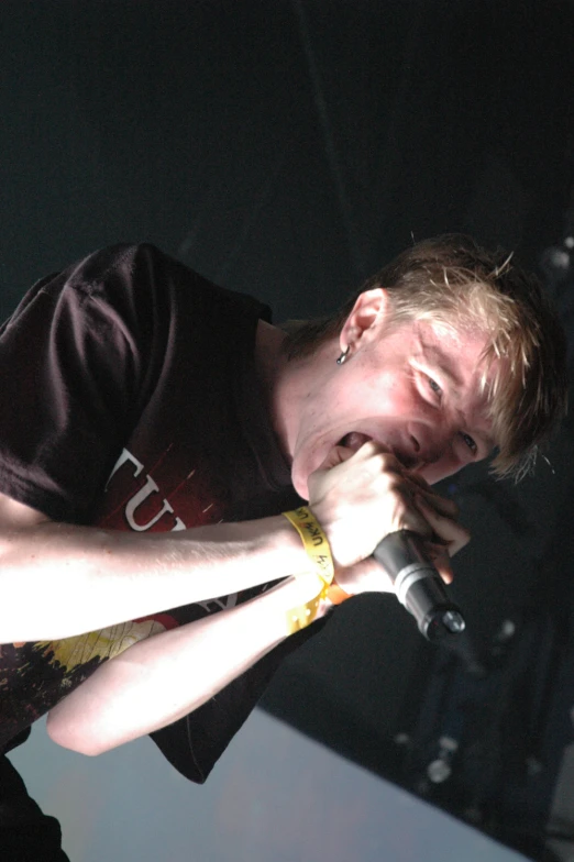 young man with microphone in hand and lighting coming from behind