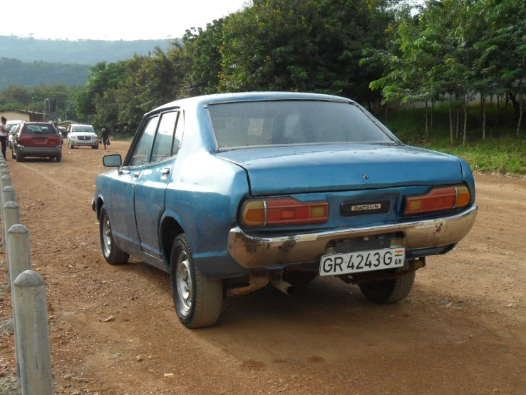 old car in a dusty area, looking a bit blurry