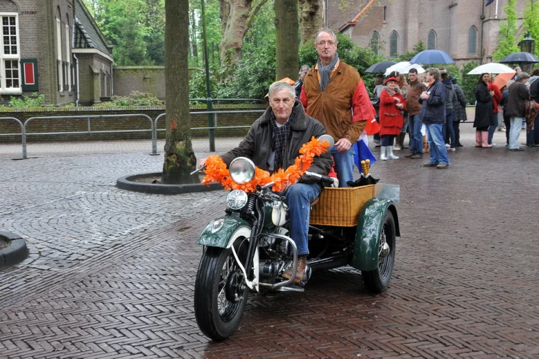 a person riding a motor cycle with a basket on the back