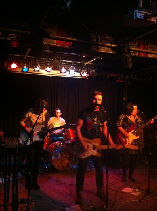 a group of people with guitars on stage