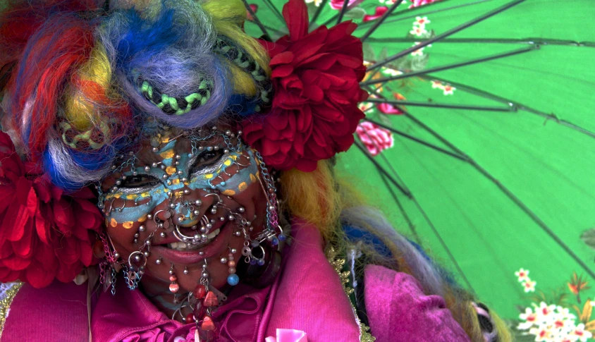 a person with many colors standing under an umbrella