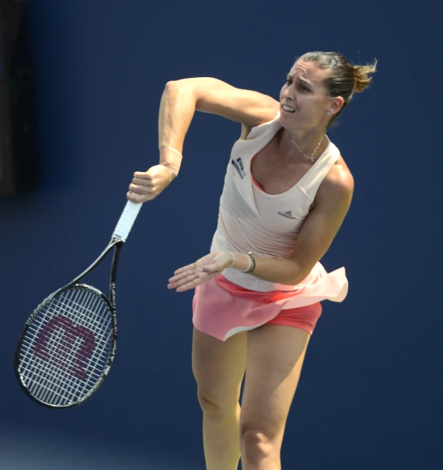 the tennis player is hitting the ball with her racket