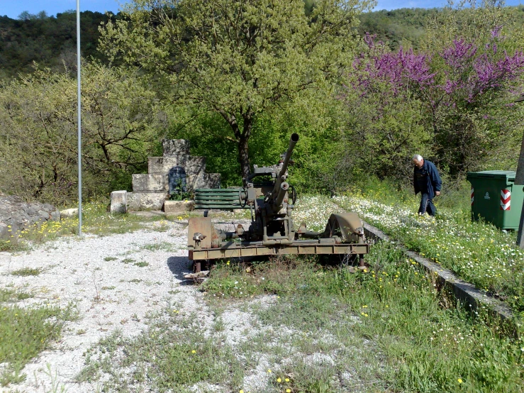 a small machine sitting on top of a lush green field