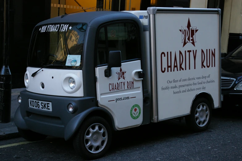 a tiny truck with its door open on the street