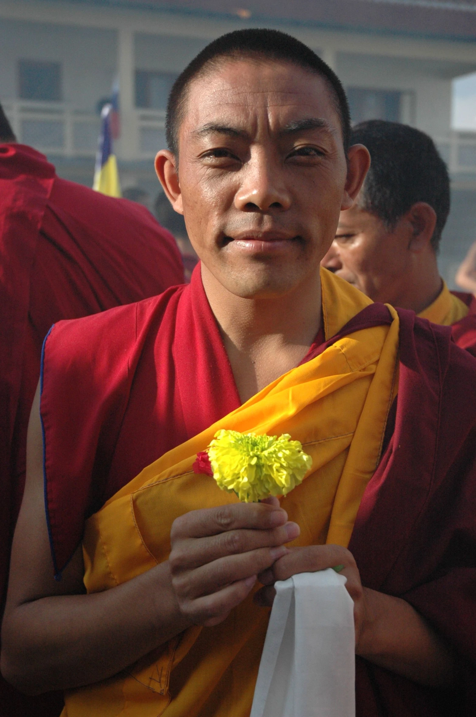 a young monk in a yellow and red outfit