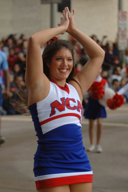 a cheerleader holding up her hands in the air