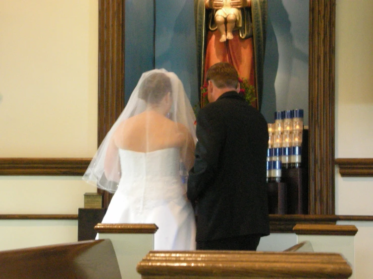 a man and woman standing in front of a statue