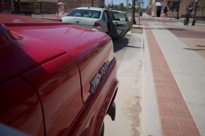 cars parked on a side walk near a sidewalk