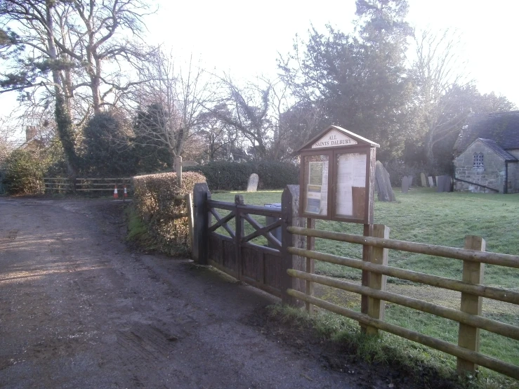 a po taken from behind the gate to a farm house