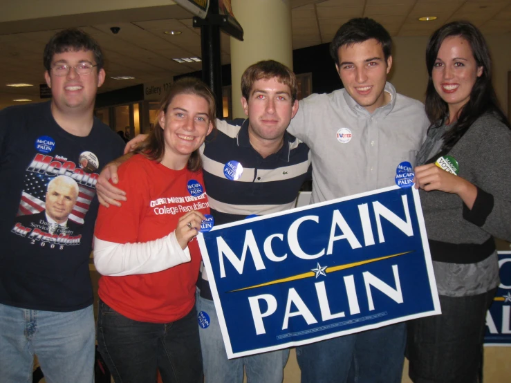 a group of people are posing in front of the mccain pali sign