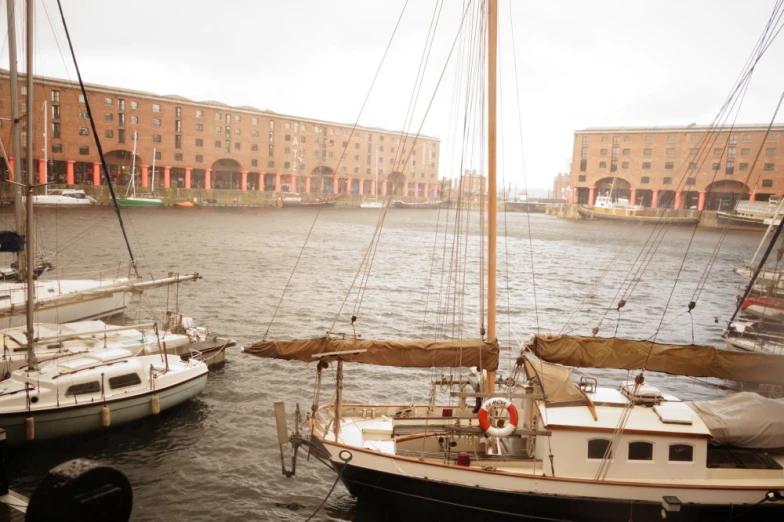 small sail boats parked near large buildings in water