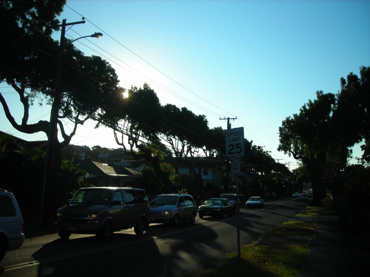 a street scene with cars parked along the side of the road