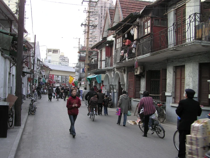 people walk along an empty street in the old city