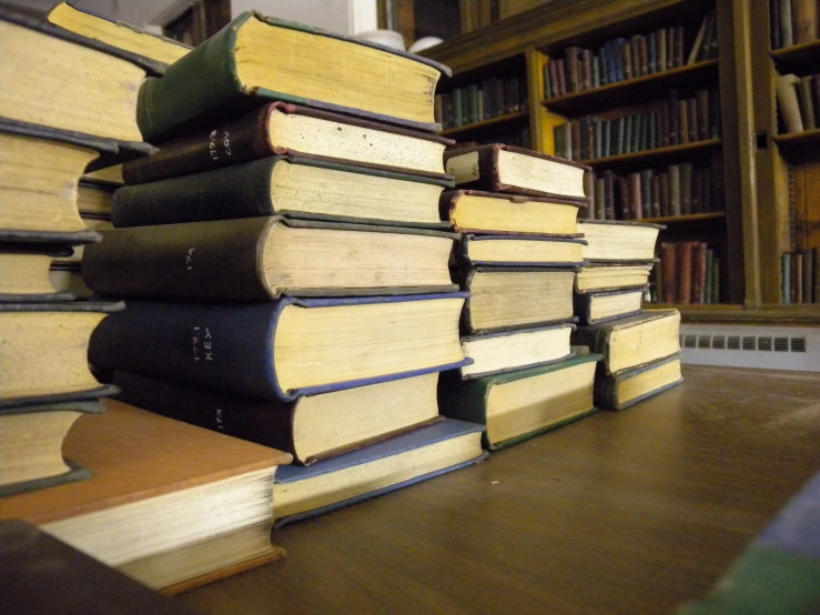 stacks of books on the floor of a liry