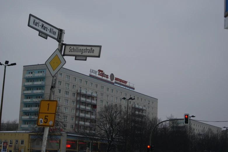 the street sign has two street signs hanging from it