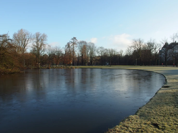 a large open area with an almost empty pond