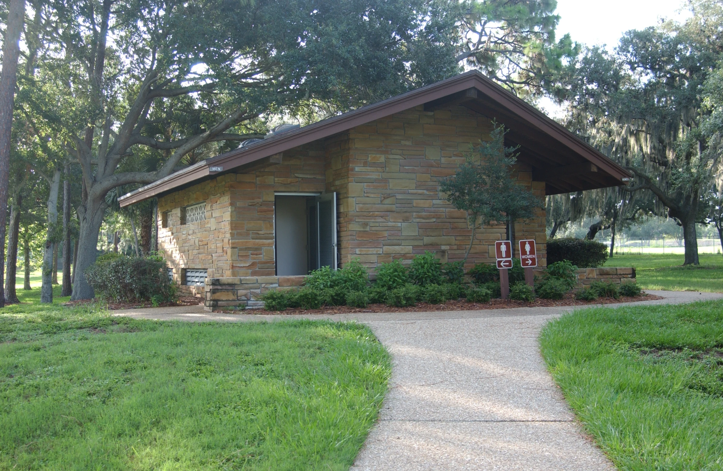 a house with trees and some grass in front