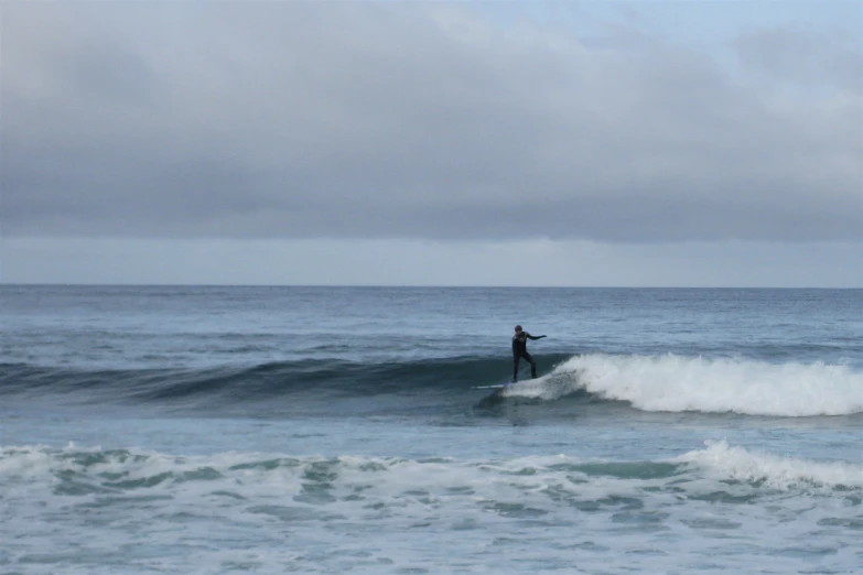 a surfer is riding a small wave on the ocean