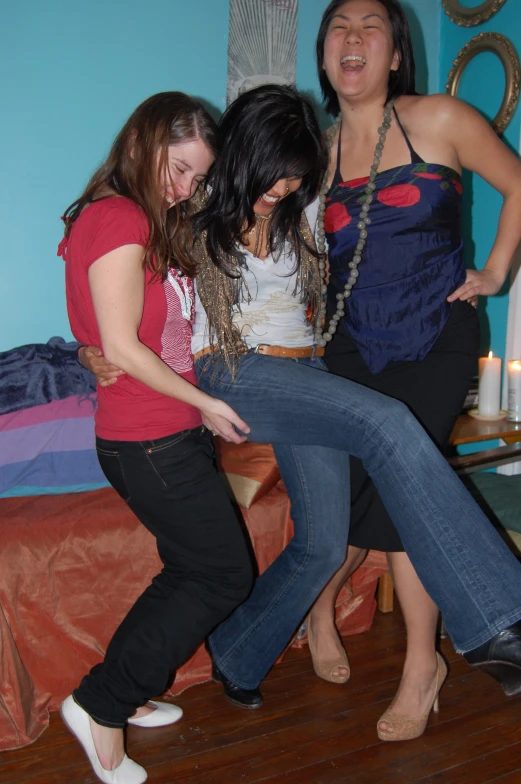 the three women are hugging each other on a bed