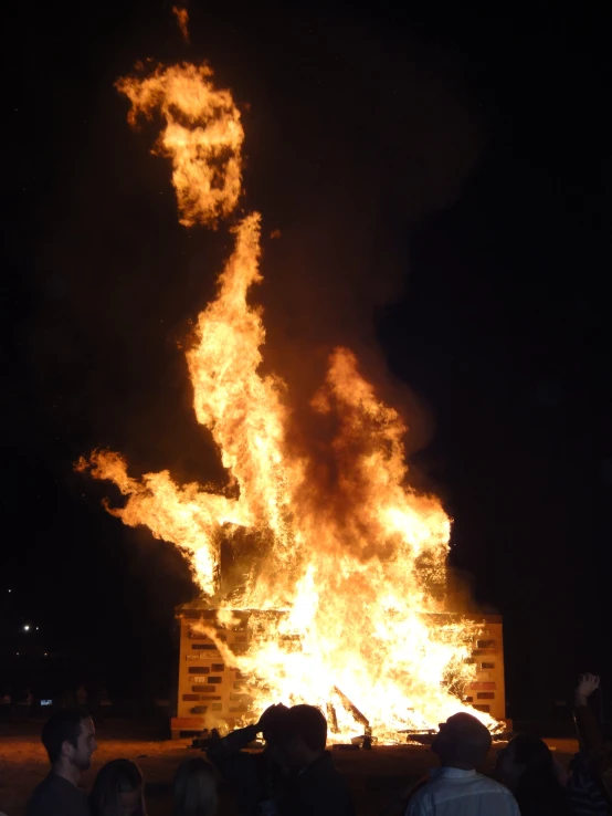 a large, fire - breathing structure in a night sky