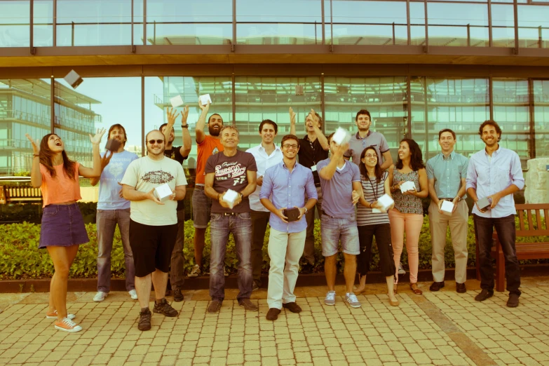 a group of people are standing outside a building and posing for a picture