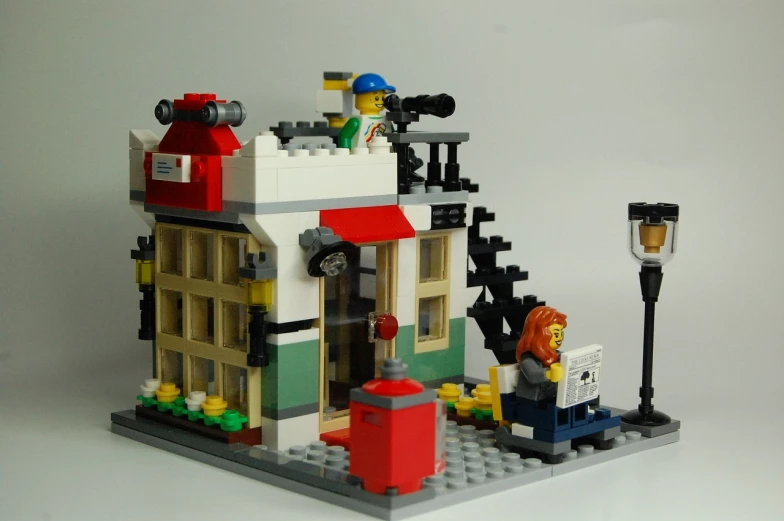 a small lego fire station with a fire hydrant on the outside