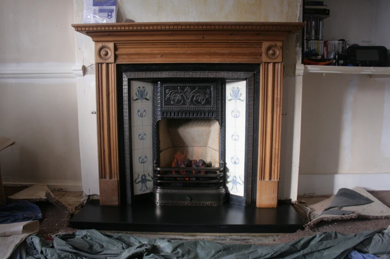 an old fashioned fireplace surrounded by other pieces of furniture