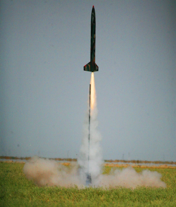 an airplane is launching in the air and emitting smoke