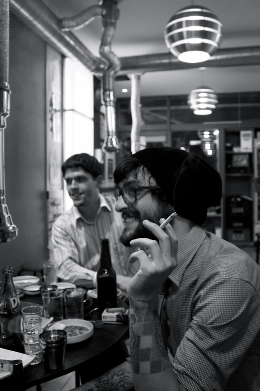 black and white pograph of two men talking on the phone