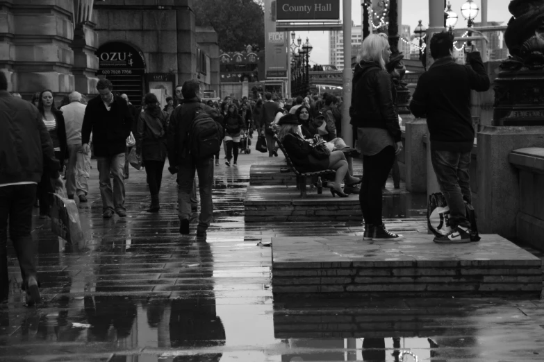 some people walking down a sidewalk under some umbrellas