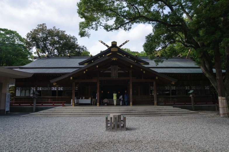 a building in the park with people walking by