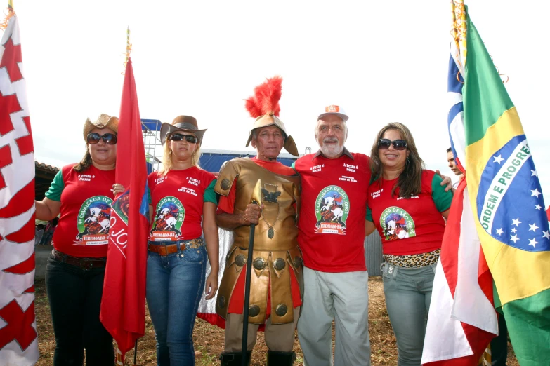 a group of people standing on top of a field holding flags