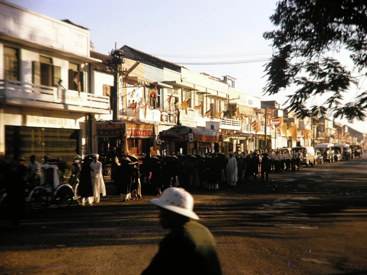 people walking down the road by many houses