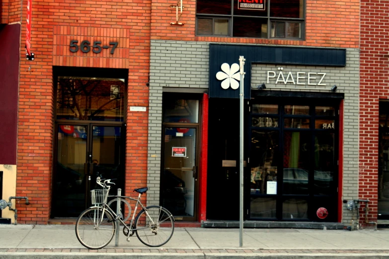 bicycle on a sidewalk outside of a store