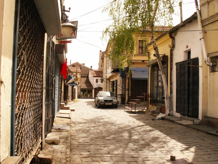 a car is parked on a narrow road