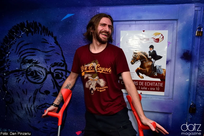 a man with arms out in front of a poster