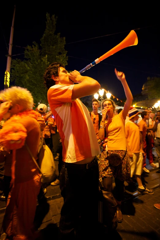 a man swinging a bat during a party in the street