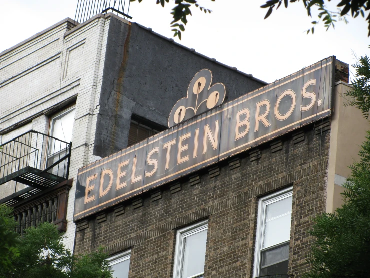 the sign for a brown ale is hanging on the outside of the building